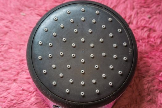 macro closeup of a eco friendly shower head with water holes, modern bathroom products