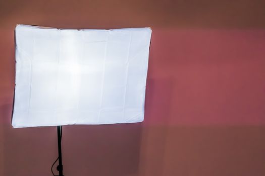 soft light box in closeup isolated on a pink wall background, Basic photo studio equipment