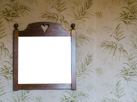 vintage room interior, empty wooden frame hanging on a retro wallpaper that is decorated with green leaves