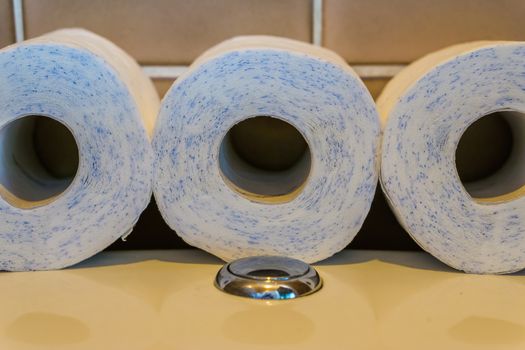 row of toilet paper rolls laying on the water closet, bathroom products, sanitary background