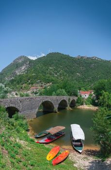 Skadar lake, Montenegro - 07.15.2018.  Panoramic view of the New Bridge over Crnojevica river, Rijeka Crnojevica, and the tourist area near the bridge, Rijeka Crnojevica.
