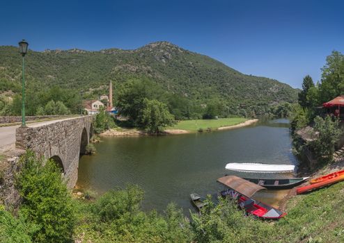 Skadar lake, Montenegro - 07.15.2018.  Panoramic view of the New Bridge over Crnojevica river, Rijeka Crnojevica, and the tourist area near the bridge, Rijeka Crnojevica.