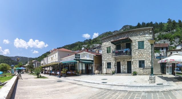 Skadar lake, Montenegro - 07.15.2018.  Panoramic view of the Old Bridge over Crnojevica river, Rijeka Crnojevica, and the tourist area near the bridge, Rijeka Crnojevica.