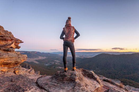 Female hiker bushwalker on summit of mountain with valley views