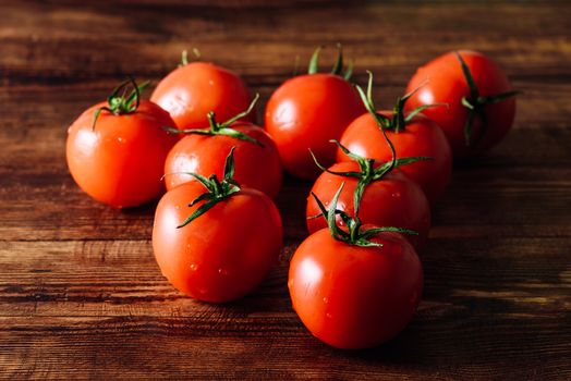 Fresh Red Tomatoes with Water Drops on Wooden Background