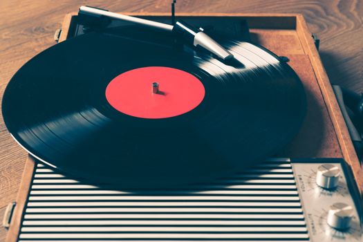 awesome vintage  Gramophone with a vinyl record on wooden table,vintage style.