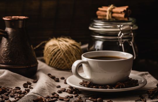 Coffee cup with various igredients, beans and kitchen equipment