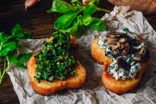 Italian Snack. Two Bruschettas with Greens and Mushrooms on Paper.