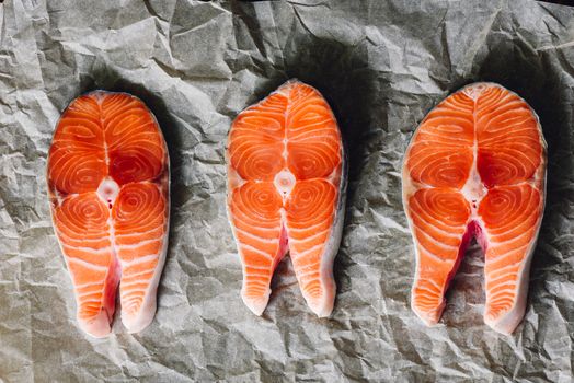 Raw Salmon Steaks on Parchment Paper. View from Above.