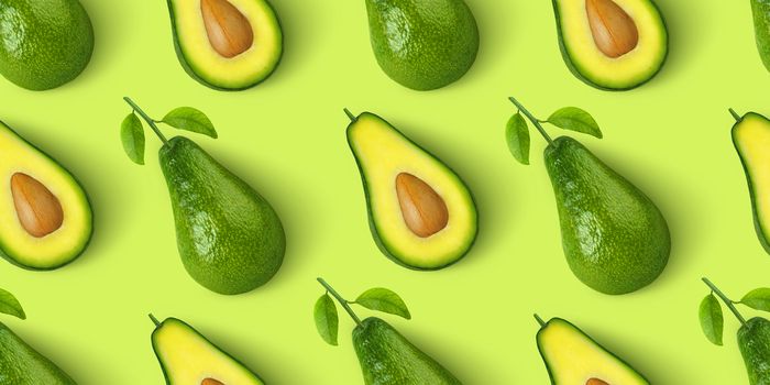 Avocado seamless pattern isolated on green background, whole and cut avocado fruit, top view