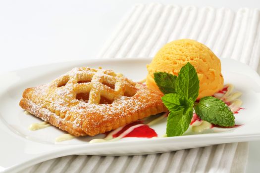 Little lattice-topped apricot pie with a scoop of ice cream