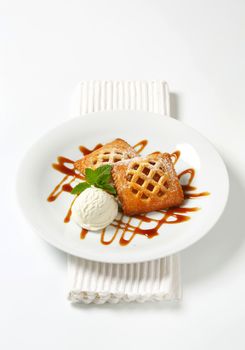 Little lattice-topped apricot pies with a scoop of ice cream