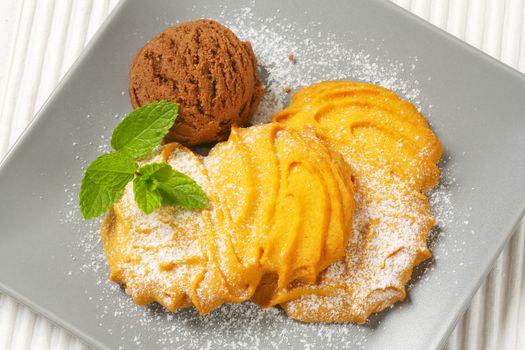 Spritz butter cookies and scoop of chocolate ice cream