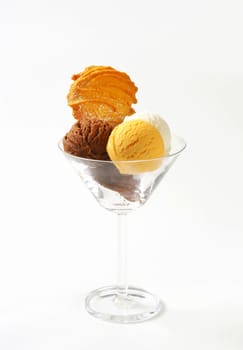 Three scoops of ice cream in glass decorated with Spritz cookie