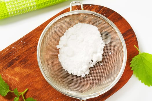Powdered sugar in a metal sieve