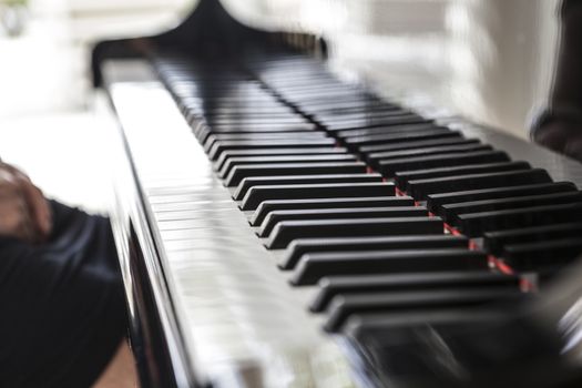 Beautiful picture of a black piano and white keys