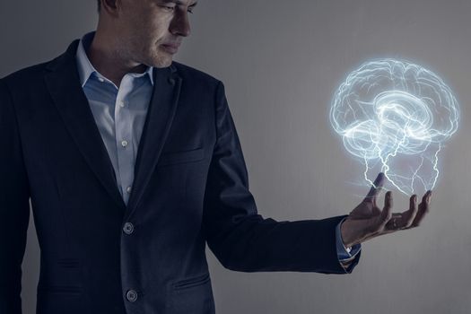 Picture of man holding a lightning strike and brain