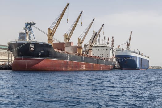 Blue ship following the working ship on water