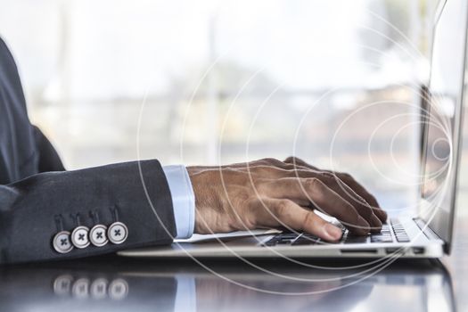 Man in suit using laptop in office