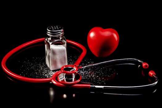 Medical instrument and salt isolated on black background with reflection