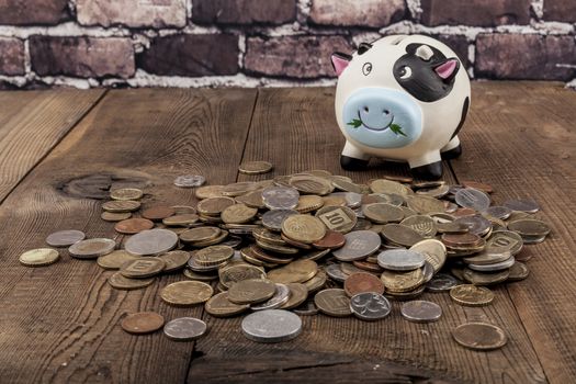 Piggy Bank on wood table and brick background