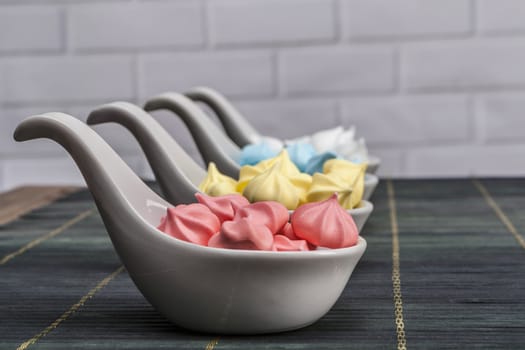 Rainbow sweets on table and brick background