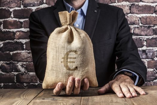 Man holding a big sack of money