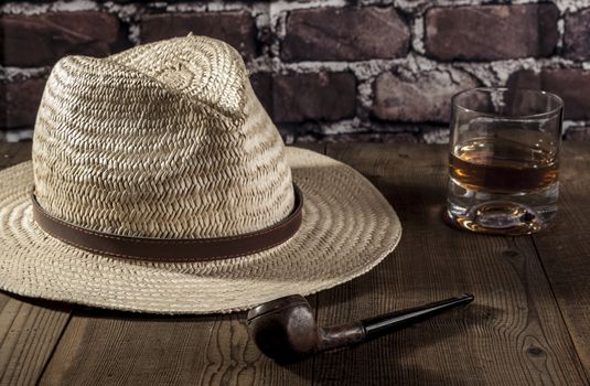 Hat and alcohol on brown wood table