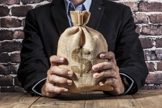 Man holding a big sack of money