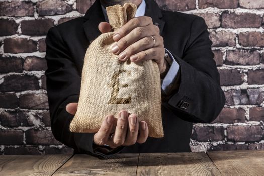 Man holding a big sack of money