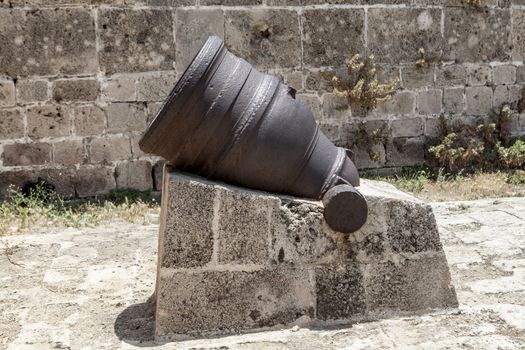 Little cannon on Rock and old walls