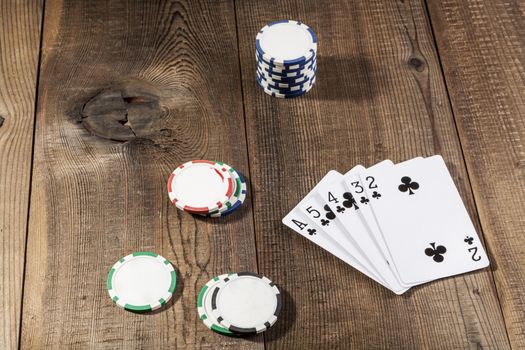 Cards and chips on brown wood table