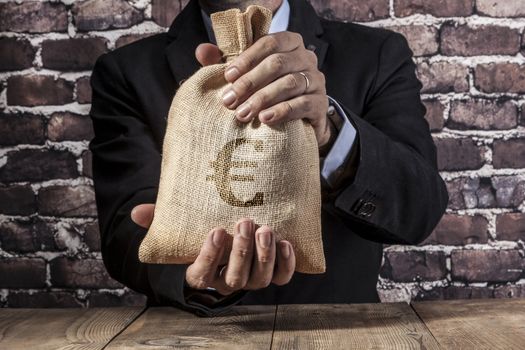 Man holding a big sack of money