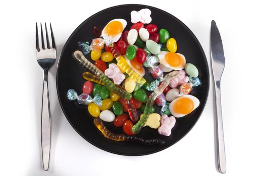 Plate with candies isolated on white background with shadow