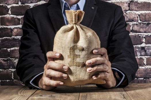 Man holding a big sack of money