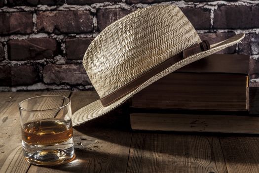 Books and hat on brown wood table