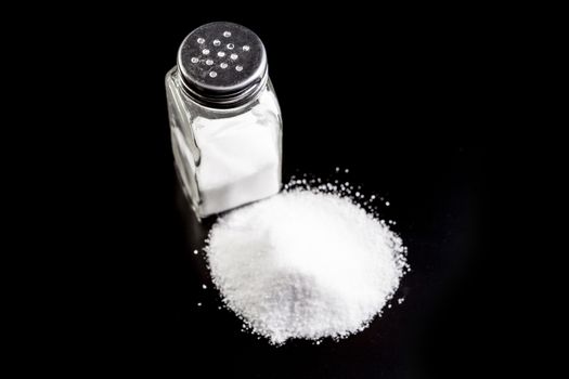 Salt isolated on black background with reflection