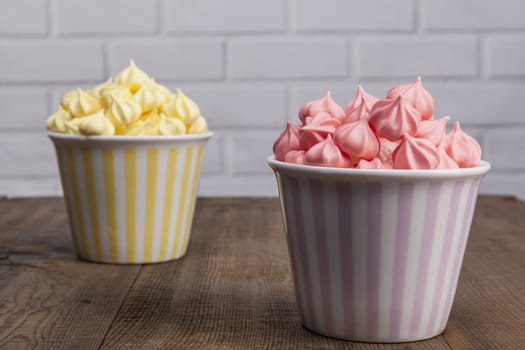 yellow and pink sweets on wood table