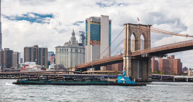 Cars pressed for recycling on tranport boat, New York, Manhattan, East River