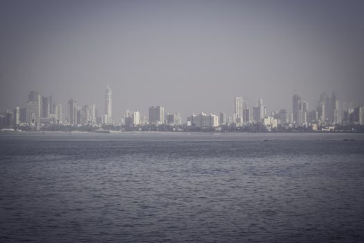 MUMBAI, INDIA - FEBRUARY 25: The Gateway of India, Sky line view Of Marine Drive shot in day light clear sky on a sunny day.