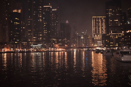 DUBAI, UNITED ARAB EMIRATES - UAE - Asia 23 APRIL 2016: Skyscrapers of City Marina at night. Panoramic skyline view lights and reflections. Famous for expensive property, high-end luxurious star hotel