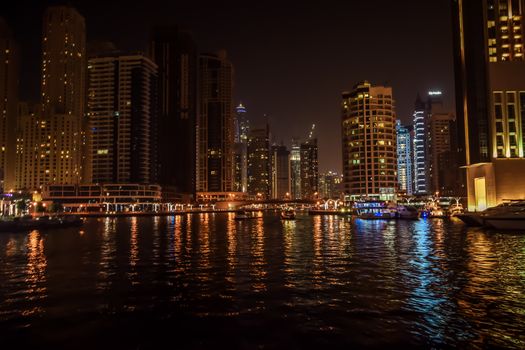 DUBAI, UNITED ARAB EMIRATES - UAE - Asia 23 APRIL 2016: Skyscrapers of City Marina at night. Panoramic skyline view lights and reflections. Famous for expensive property, high-end luxurious star hotel