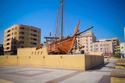 Old wooden heritage ship boat antique called a Dhow outside the Dubai museum in UAE ( united arab emirates)