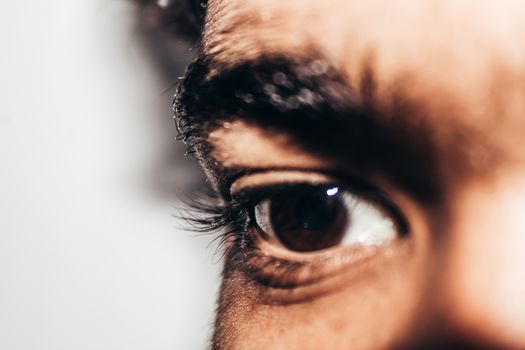 Macro shot of young man's eye: The human eye sideways, Close-up, isolated on white background