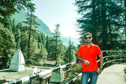 A man standing in the heart of Manali City, Himachal Pradesh, Kullu, India. It is a popular tourist destination in northern India.