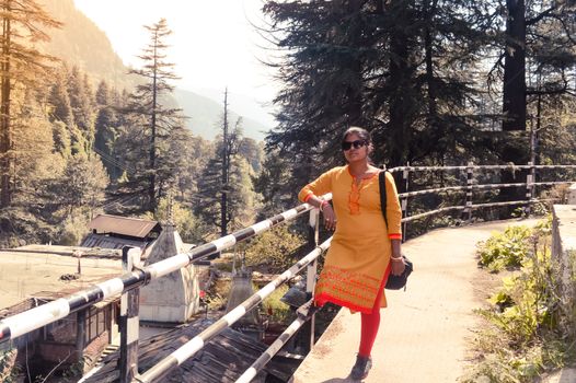 A woman standing in the heart of Manali City, Himachal Pradesh, Kullu, India. It is a popular tourist destination in northern India.
