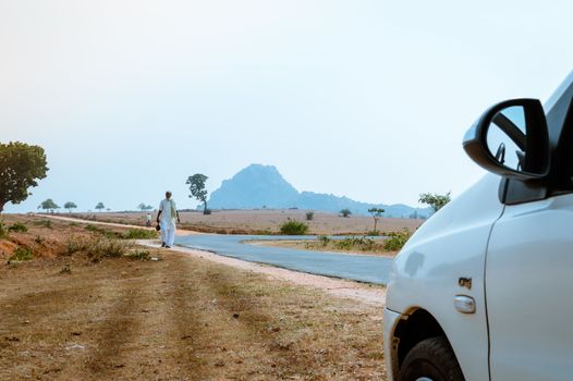 KHANDOLI , JHARKHAND, INDIA - JAN 25: A lonely people walking in empty street on a sunny summer day. It is an important tourist spot. It was believed to be a popular Maoist area earlier.