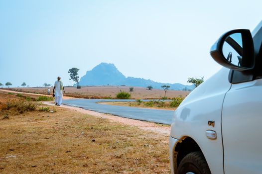 KHANDOLI , JHARKHAND, INDIA - JAN 25: A lonely people walking in empty street on a sunny summer day. It is an important tourist spot. It was believed to be a popular Maoist area earlier.