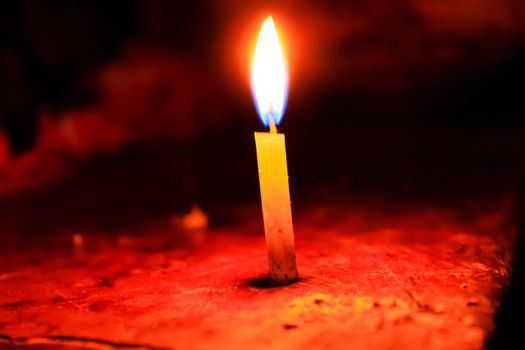 Candle spreading light isolated on blur background