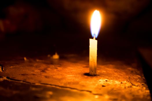 Candle spreading light isolated on blur background